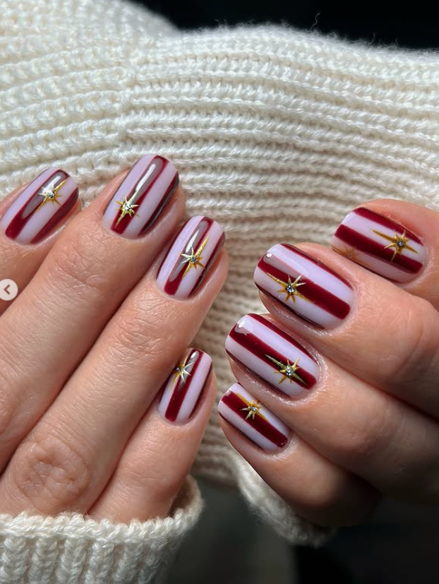 red and white striped nails with gold accent stars